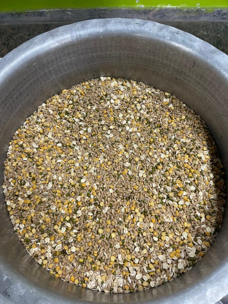 Dry multigrain atta mix in a large metal preparation bowl